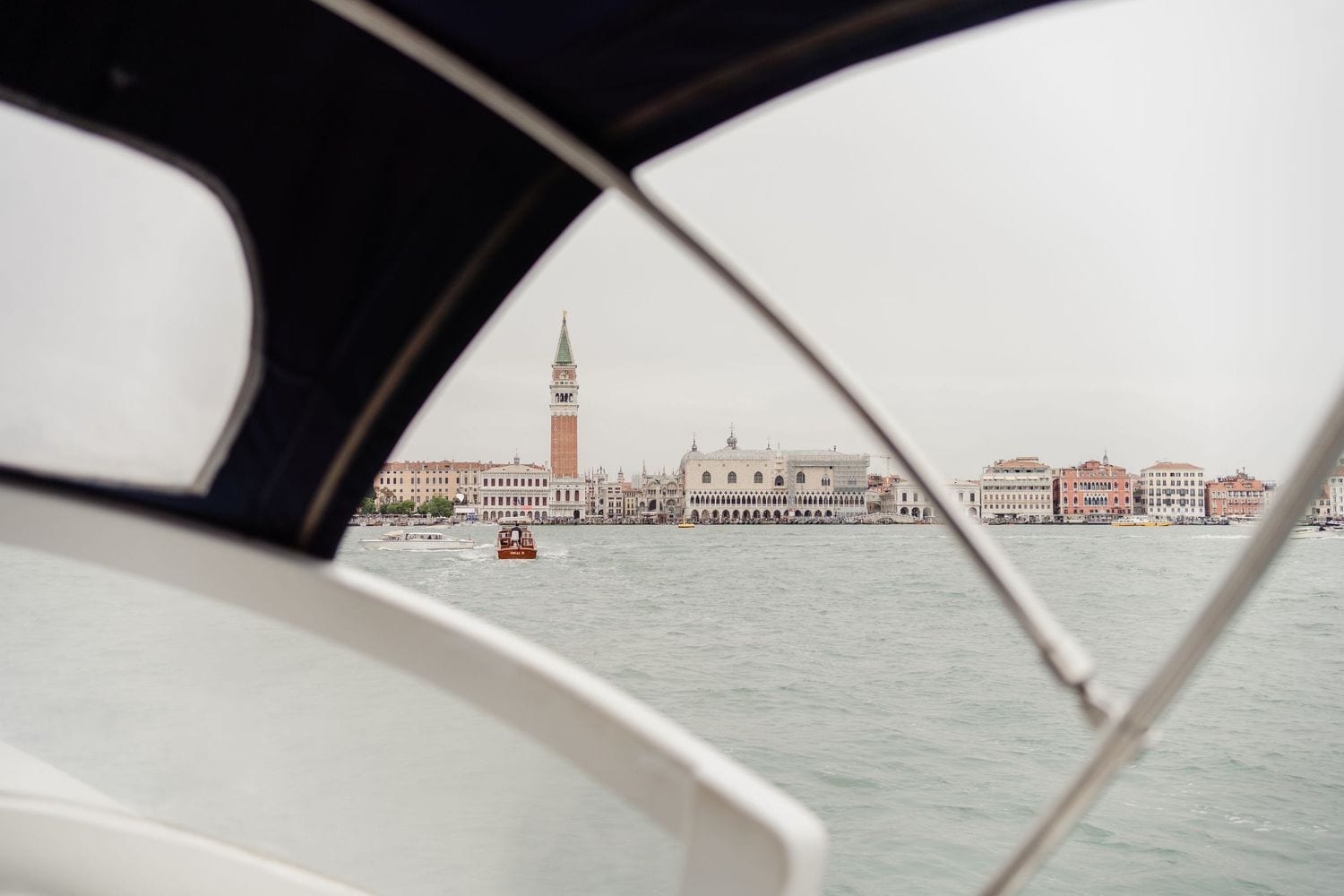 View of Venice skyline with St. Mark's Campanile from a Venetian taxi on the Grand Canal