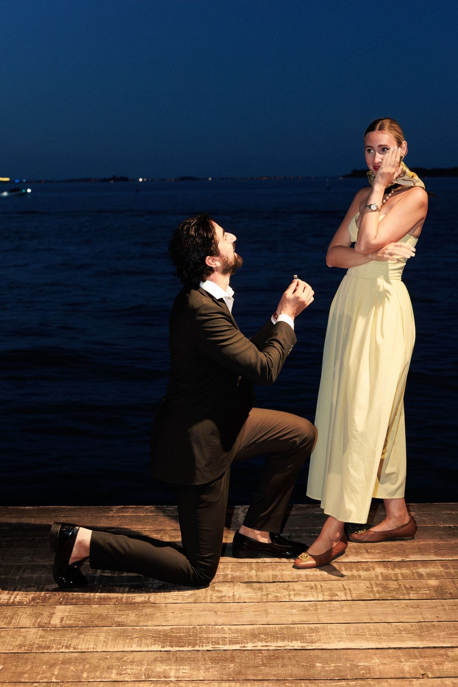 Surprise proposal on a private pontoon in Venice at dusk