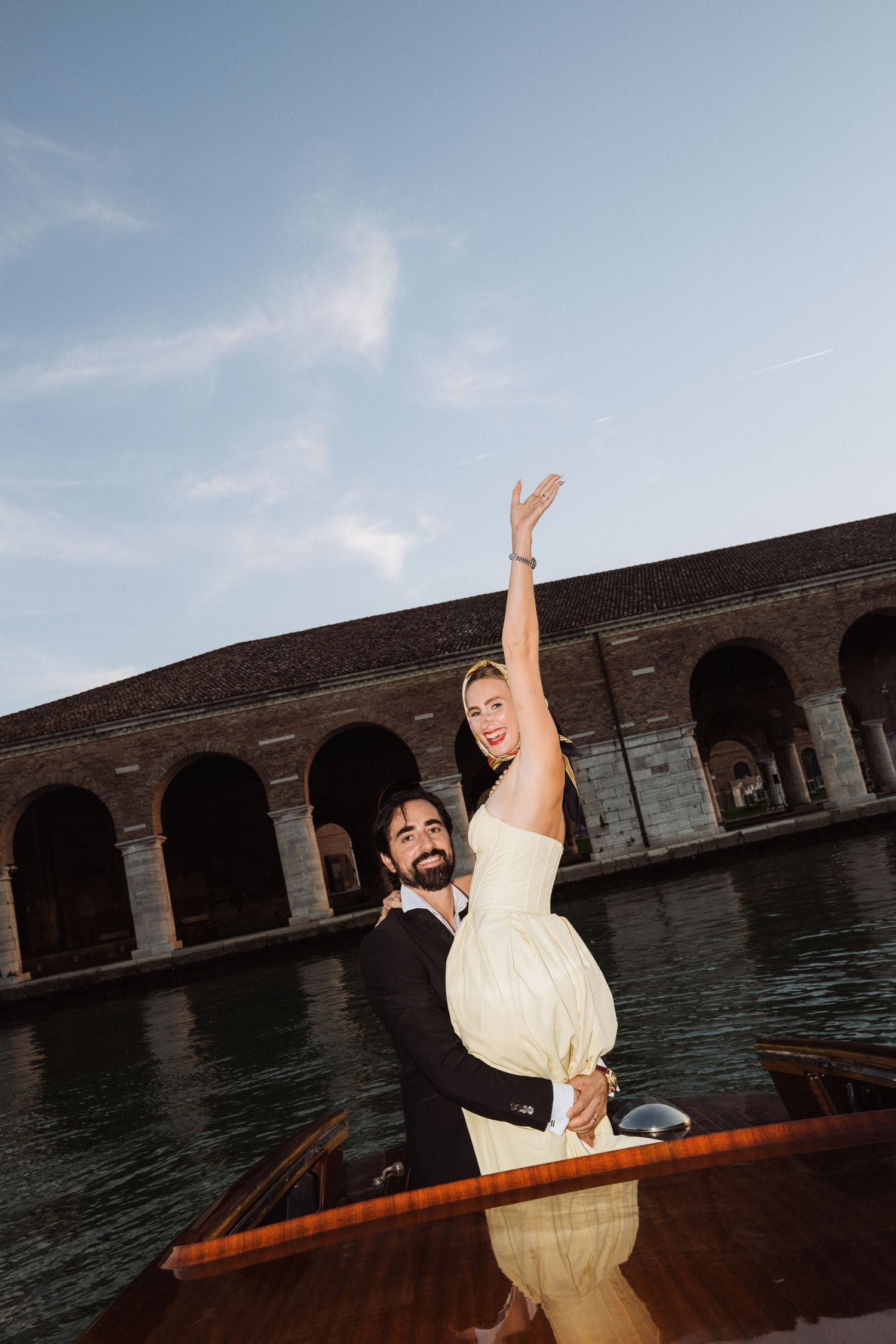 Couple on a Venetian water taxi near the Arsenale during their engagement session