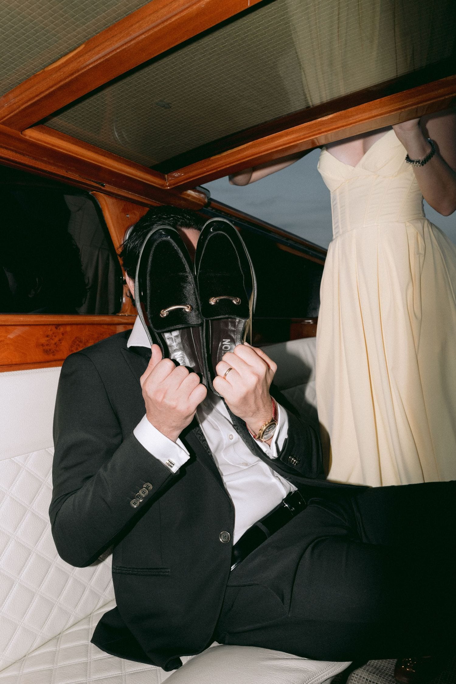Playful portrait of the groom-to-be inside a Venetian water taxi before the proposal