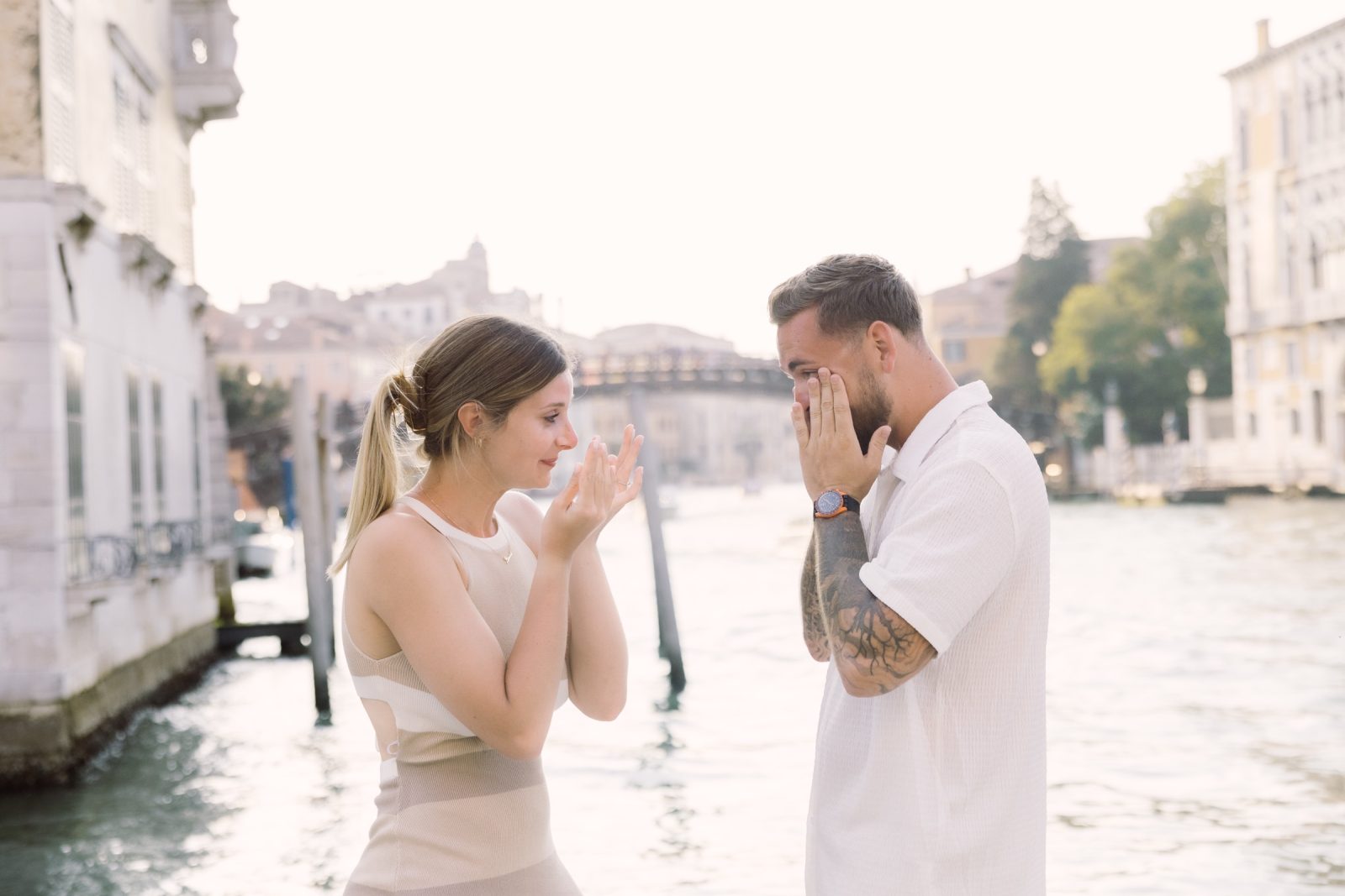 Joseph and Gianna wiping away tears after their surprise proposal beside the Grand Canal in Venice